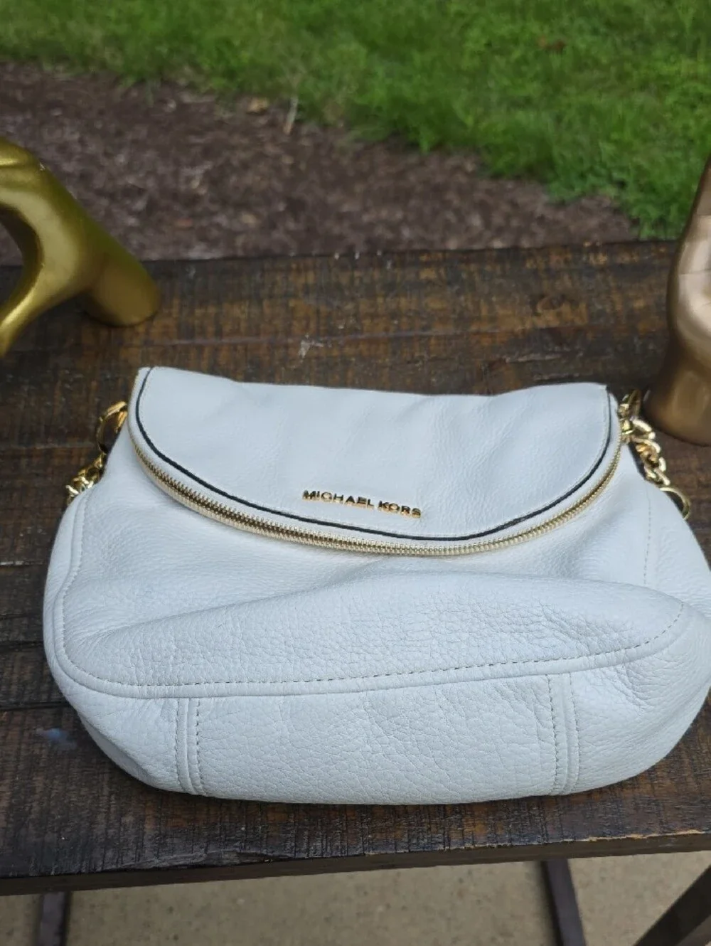 Michael Kors Bedford shoulder bag features a fold-over zipper flap